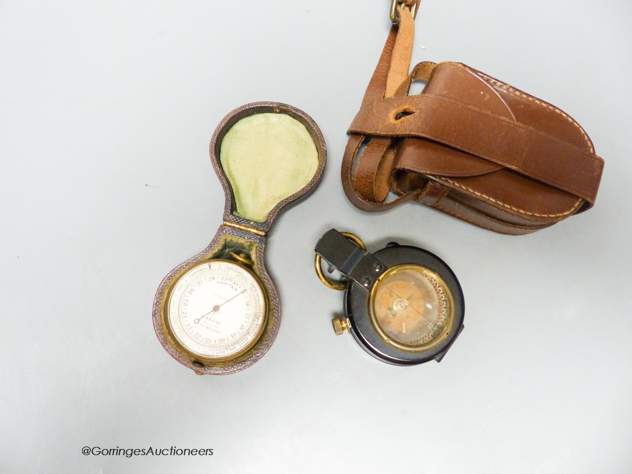 A small leather-cased military compass together with a cased compensated pocket barometer, E.Bryan, Manchester (2)